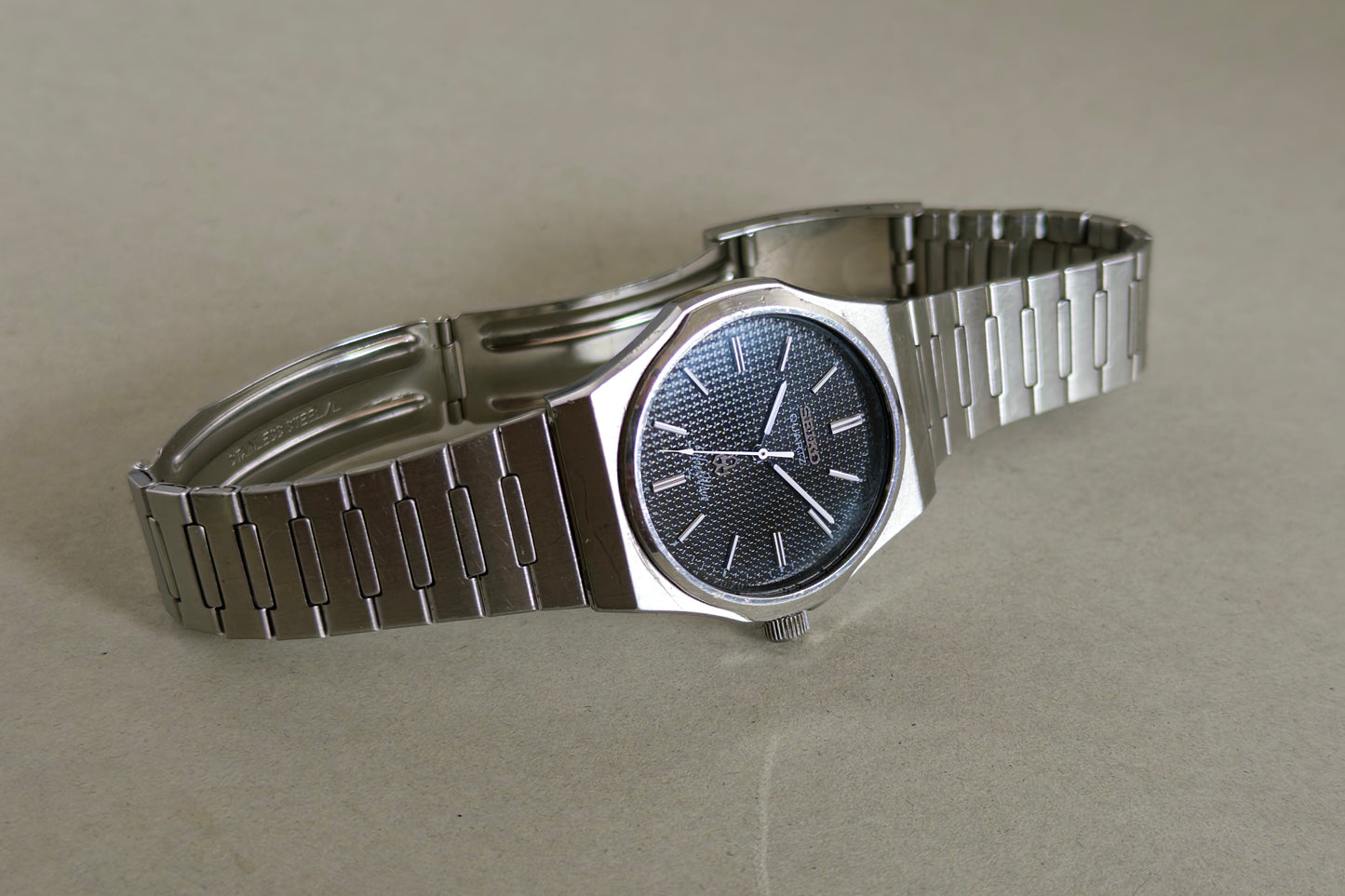 Seiko Silverwave 7121-703B at an angle, its black dial catching a blue reflection