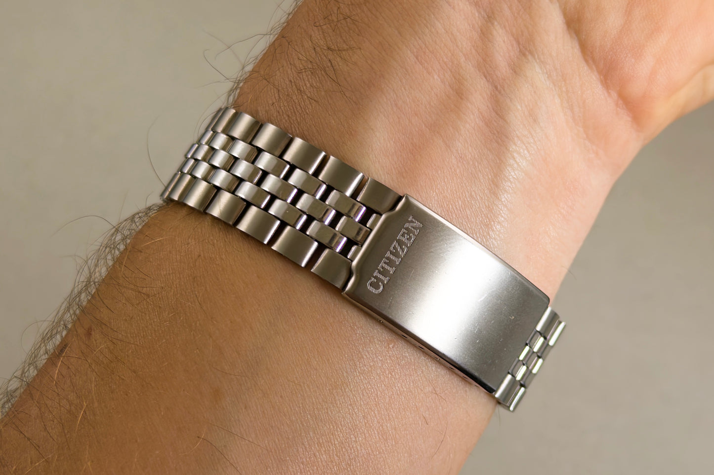 Signed Citizen clasp of the beads-of-rice bracelet closed on the wrist
