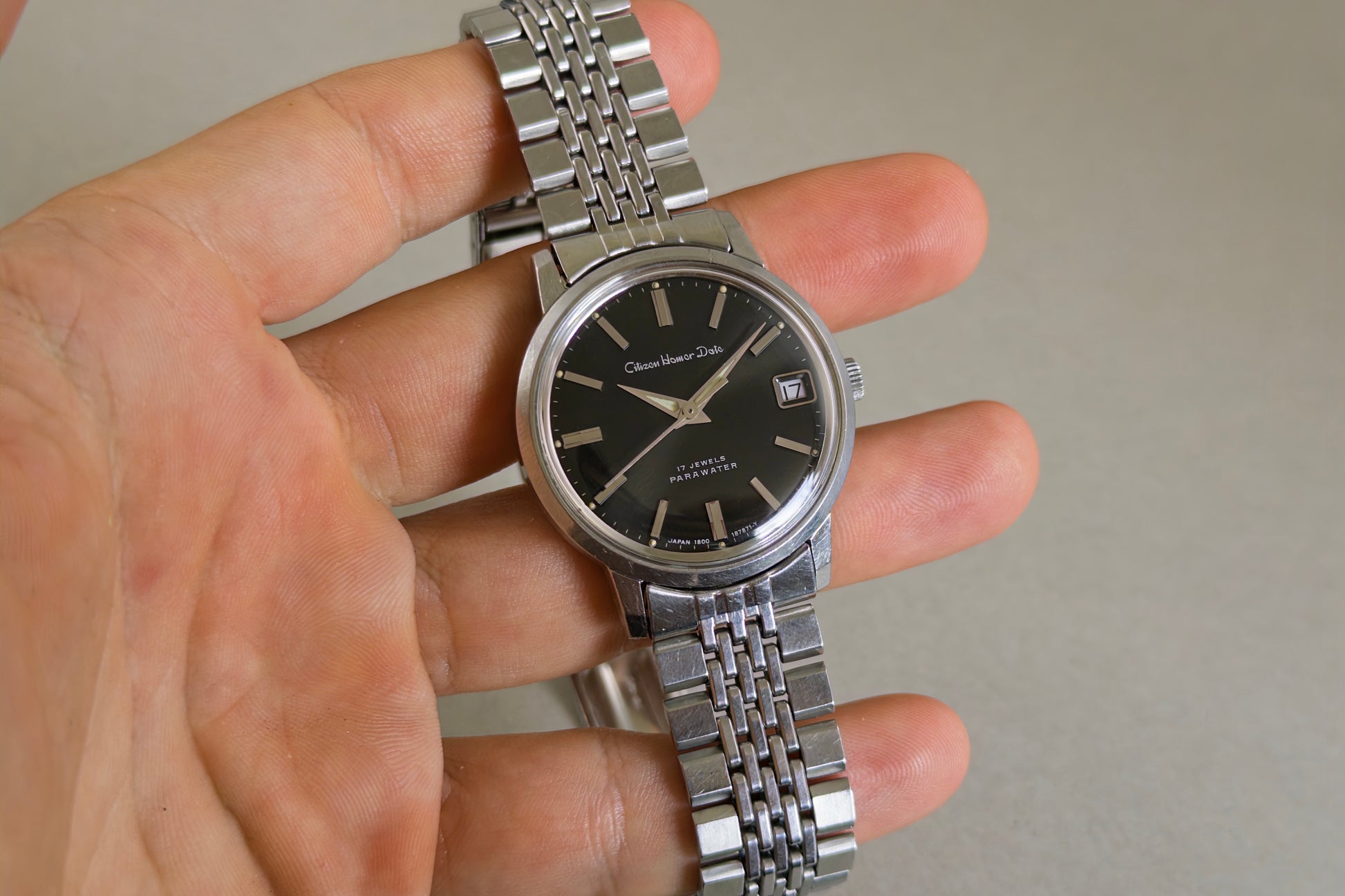 Citizen Homer Date 63-2058 held in hand showing its 17-jewel Parawater dial