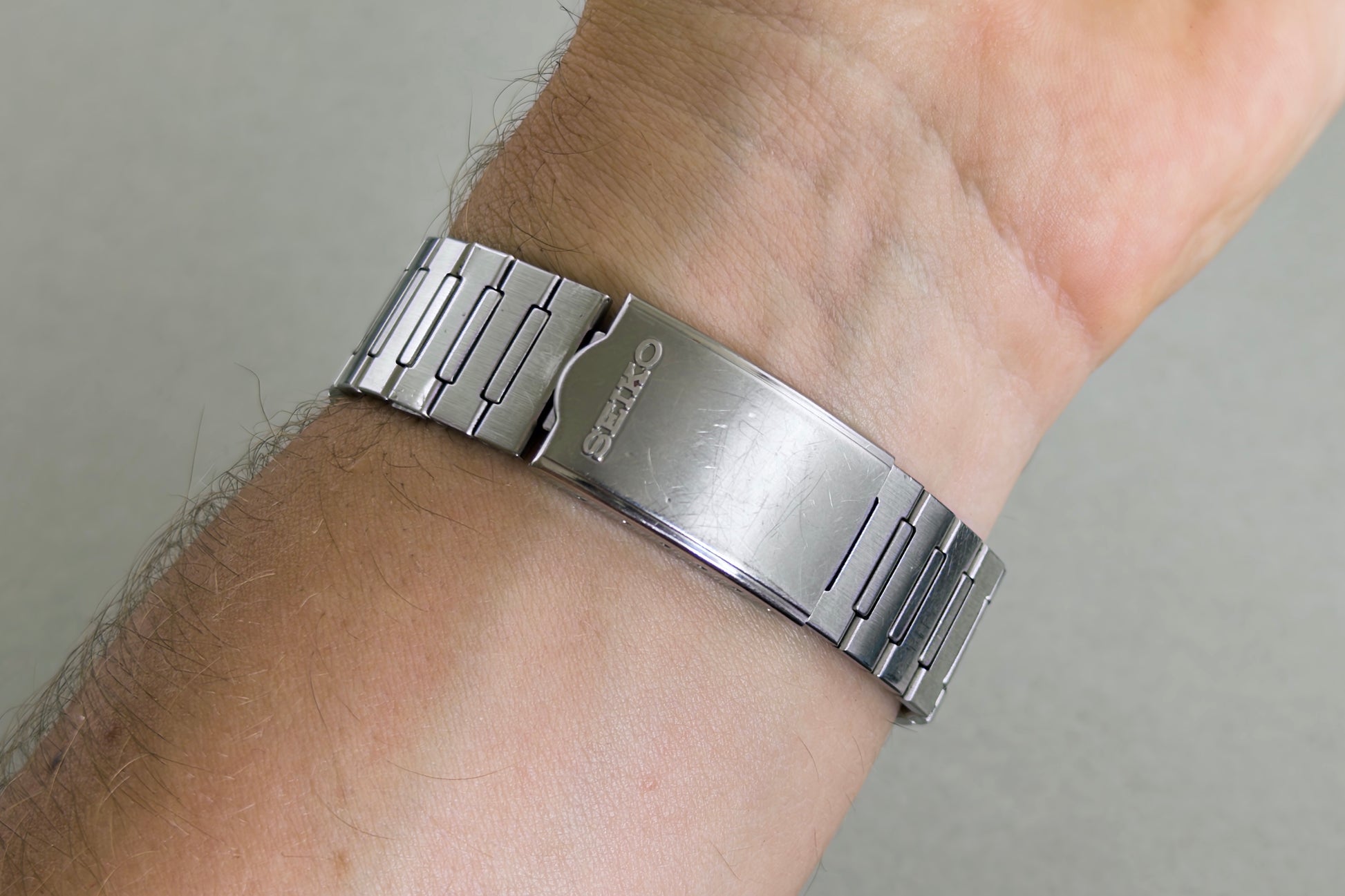 Signed Seiko folding clasp of the Silverwave bracelet closed on the wrist