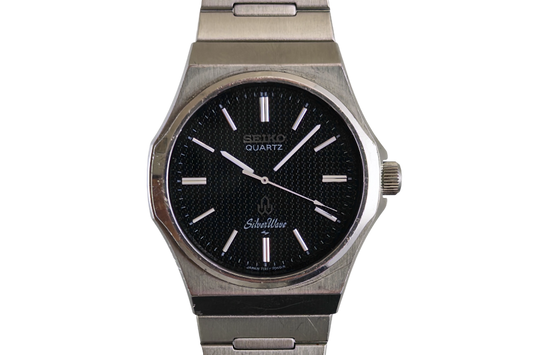 Seiko Silverwave 7121-703B from 1980 with black textured dial and integrated steel bracelet