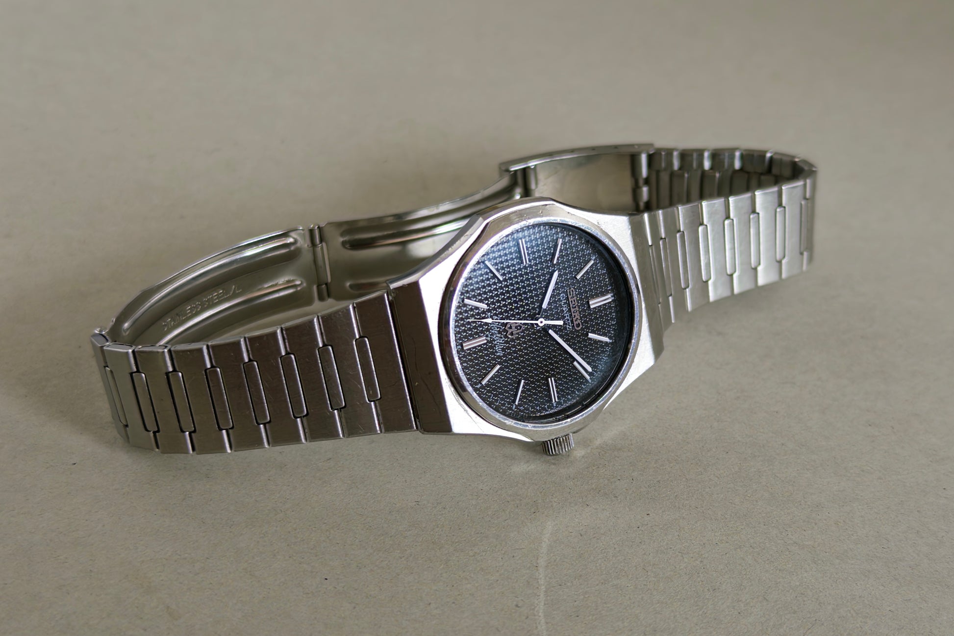 Seiko Silverwave 7121-703B at an angle, its black dial catching a blue reflection